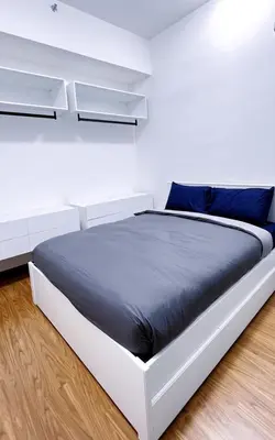 a white bed in a white room with blue pillows at Beacon Executive Suites #Georgetown #RoofTopPool #23A in George Town
