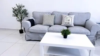 a living room with a couch and a table at Beacon Executive Suites #Georgetown #RoofTopPool #23A in George Town