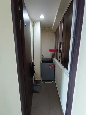 a hallway leading into a room with a refrigerator at Lovers Island homestay in Batu Ferringhi