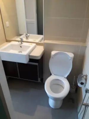 a bathroom with a white toilet and a sink at Lovers Island homestay in Batu Ferringhi