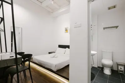 a bedroom with a bed and a toilet and a sink at Kangsar Inn 73 in George Town