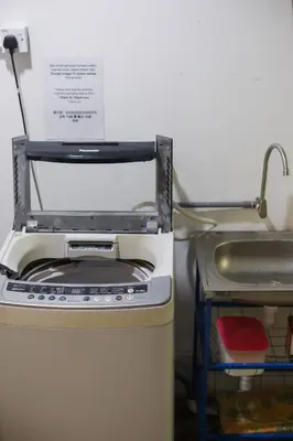 a kitchen with a stove and a sink at Kangsar Inn 73 in George Town