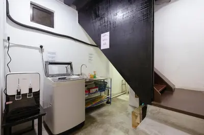a small kitchen with a sink and a stairway at Kangsar Inn 73 in George Town
