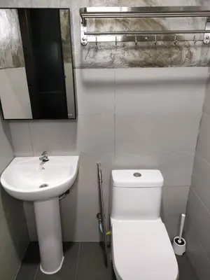 a bathroom with a white toilet and a sink at Studio Amani 1 Permatang Pauh in Permatang Pauh