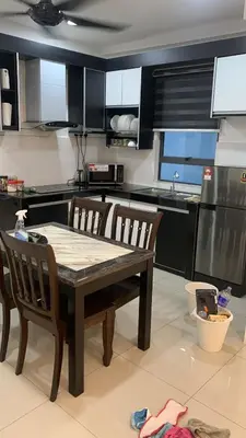 a kitchen with a wooden table and two chairs at SM Homestay @ Meru Casa Kayangan in Ipoh