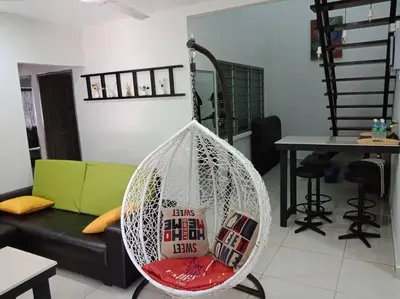 a hanging hammock in a living room with a couch at AVENUE HOMESTAY 5 Room 4 Toilet 4 MINUTES TO TOWER in Teluk Intan
