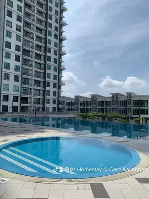 a large swimming pool in front of some tall buildings at Barakah Homestay @ Meru Casa Kayangan in Ipoh
