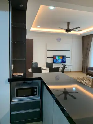 a kitchen and living room with a counter top at Barakah Homestay @ Meru Casa Kayangan in Ipoh