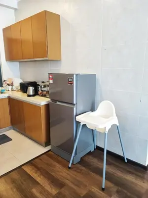 a kitchen with a refrigerator and a chair in it at Muji Homestay @ The Retreat, Cameron Highlands in Cameron Highlands