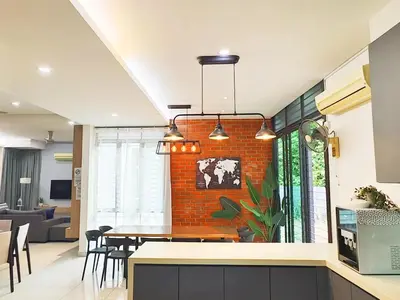 a kitchen and dining room with a brick wall at Ocean 23 Batu Ferringhi Shamrock Beach with Swimming Pool 7 Bedroom 30pax in Batu Ferringhi