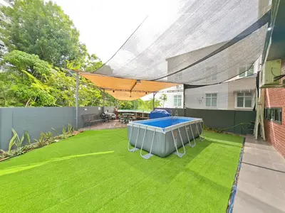 a backyard with a ping pong table on the grass at Ocean 23 Batu Ferringhi Shamrock Beach with Swimming Pool 7 Bedroom 30pax in Batu Ferringhi