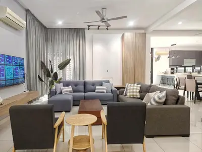 a living room with a couch and a table at Ocean 23 Batu Ferringhi Shamrock Beach with Swimming Pool 7 Bedroom 30pax in Batu Ferringhi