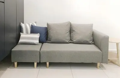 a couch with four pillows on it in a room at Ocean 23 Batu Ferringhi Shamrock Beach with Swimming Pool 7 Bedroom 30pax in Batu Ferringhi
