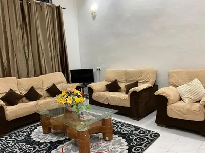 a living room with two couches and a coffee table at AlFarizqi Muslim Residence SP in Sungai Petani