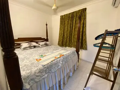 a bedroom with a bed with a ladder next to a window at AlFarizqi Muslim Residence SP in Sungai Petani