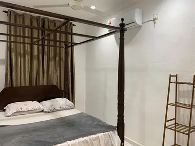 a bed with a black canopy bed frame in a room at AlFarizqi Muslim Residence SP in Sungai Petani