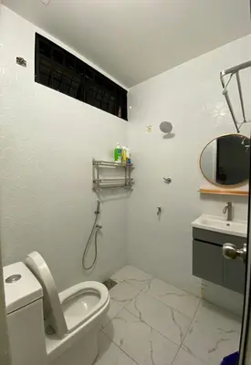 a white bathroom with a toilet and a sink at AlFarizqi Muslim Residence SP in Sungai Petani
