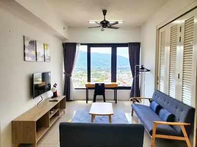 a living room with a blue couch and a table at The MINDI, 2BR Cityview by WStay @ Tropicana 218 Macalister in George Town
