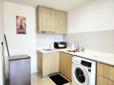 a small kitchen with a washing machine in it at The MINDI, 2BR Cityview by WStay @ Tropicana 218 Macalister in George Town