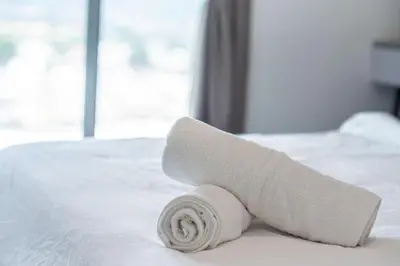 a roll of toilet paper sitting on a bed at De Luma-Metropol in Bukit Mertajam