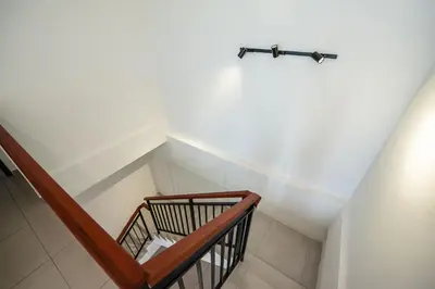 a staircase in a room with a stair railing at De Luma-Metropol in Bukit Mertajam