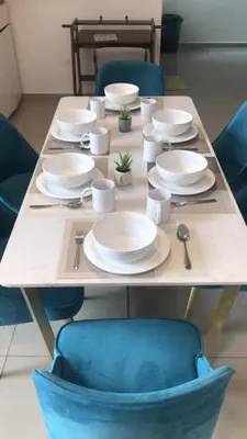 a table with white plates and utensils on it at De Luma-Metropol in Bukit Mertajam