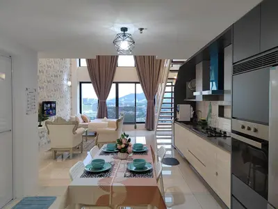 a kitchen and living room with a table and chairs at Gurney Duplex / 2bedrooms / 8pax in George Town
