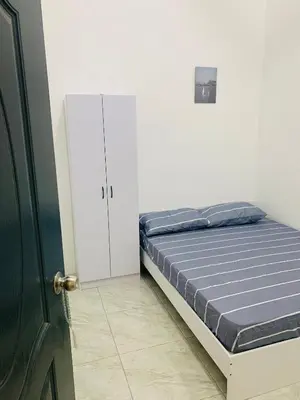 a bedroom with a bed and a white cabinet at Bonda Homestay Selama - Musllim Only in Selama