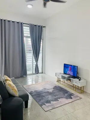 a living room with a couch and a tv at Bonda Homestay Selama - Musllim Only in Selama