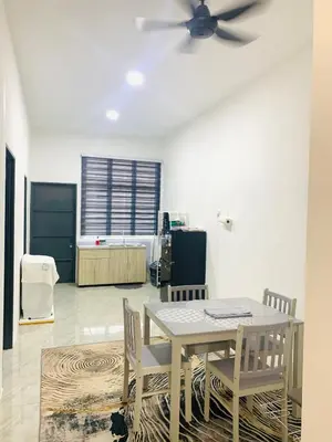 a dining room with a table and chairs and a ceiling fan at Bonda Homestay Selama - Musllim Only in Selama