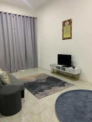 a living room with a couch and a tv at Bonda Homestay Selama - Musllim Only in Selama