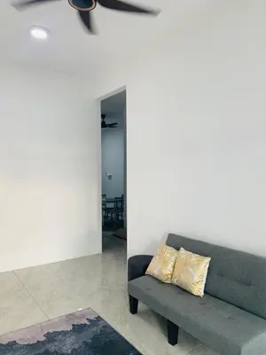 a living room with a couch and a table at Bonda Homestay Selama - Musllim Only in Selama
