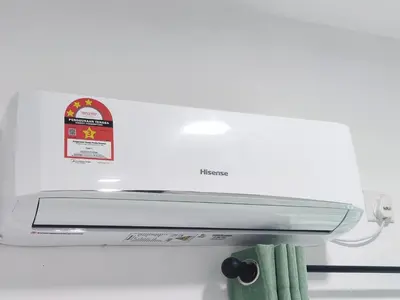 a white refrigerator freezer with a green towel at Cosy Apartment Ipoh Town - WiFi Netflix FREE in Ipoh
