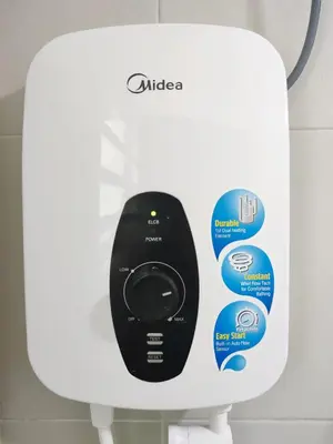 a remote control sitting on top of a toilet dispenser at Cosy Apartment Ipoh Town - WiFi Netflix FREE in Ipoh
