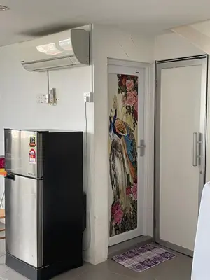 a kitchen with a painting on the wall next to a refrigerator at 6PAX ONE BEDROOM SOHO near USM SPICE ARENA PANTAI SPECIALIST AIRPORT in Bayan Lepas