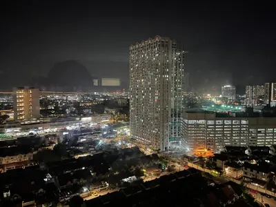 a tall building in a city at night at 6PAX ONE BEDROOM SOHO near USM SPICE ARENA PANTAI SPECIALIST AIRPORT in Bayan Lepas
