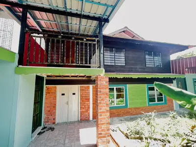 a house with a door and a balcony at Halim's Rumah Singgah Mxslim only in Jelutong