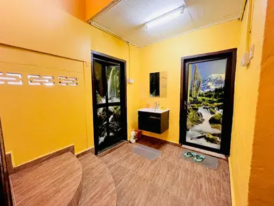 a bathroom with a sink and a yellow wall at Halim's Rumah Singgah Mxslim only in Jelutong