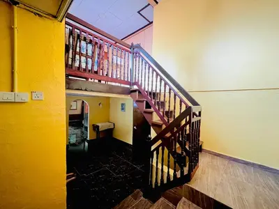 a hallway with a spiral staircase in a building at Halim's Rumah Singgah Mxslim only in Jelutong
