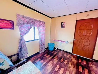 a room with a bed and a window and a door at Halim's Rumah Singgah Mxslim only in Jelutong