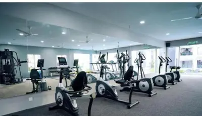 a gym with a row of treadmills and exercise bikes at Cozy homestay Manhattan Ipoh,12 pax \u6021\u4fdd\u6c11\u5bbf in Ipoh