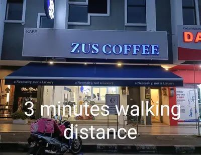 a zus coffee store with a motorcycle parked in front at Cozy homestay Manhattan Ipoh,12 pax \u6021\u4fdd\u6c11\u5bbf in Ipoh