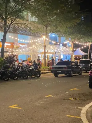 a group of motorcycles parked in front of a building with lights at 4 PAX ONE BEDROOM SOHO near USM SPICE ARENA AIRPORT MUTIARA SPECIALIST in Bayan Lepas