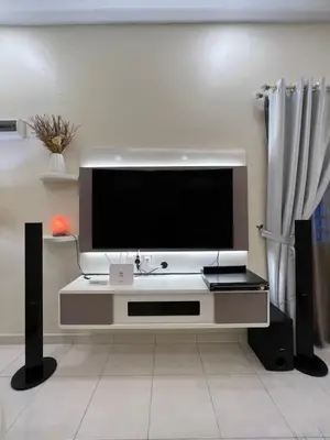 a flat screen tv on a stand in a living room at Entire Vacation Home with landscape garden in Sitiawan