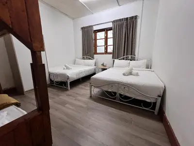 a room with two beds and a window at Mountain View Guesthouse Cameron Highlands in Tanah Rata