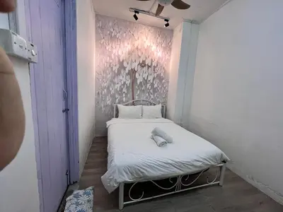 a small bed in a room with a wall at Mountain View Guesthouse Cameron Highlands in Tanah Rata