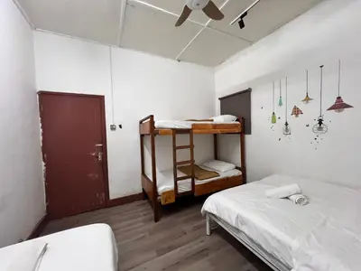 a bedroom with two bunk beds and a ceiling fan at Mountain View Guesthouse Cameron Highlands in Tanah Rata