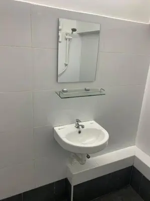 a white bathroom with a sink and a mirror at 4PAX near USM n Pantai Hospital n PISA SPI CE ARENA in Bayan Lepas