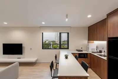 a kitchen and dining room with a table and chairs at Codrington House - Boutique Apartments in George Town