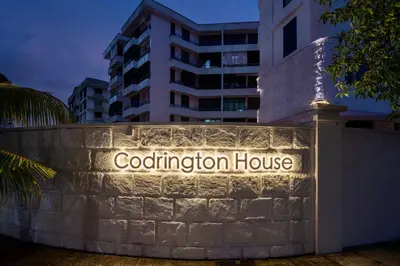 a building with a sign for a cold fusion house at Codrington House - Boutique Apartments in George Town